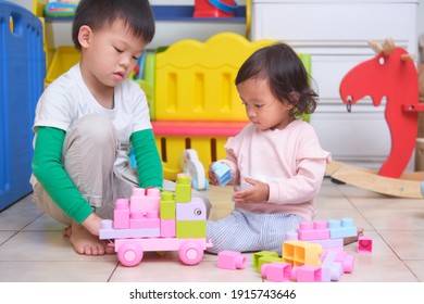 Asian Cute Big Brother And Little Sister Having Fun Playing With Toy Blocks In Play Room At Home, Educational Toys For Young Kid, Bonding Of Sibling, Learn Through Play, Child Development Concept