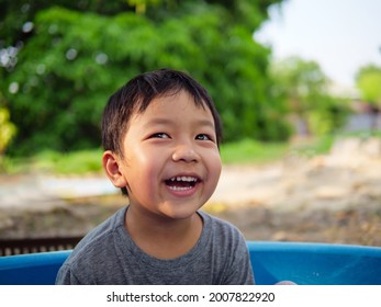 Asian cute child boy smiling and laughing with whitening teeth in nature background with thinking, funny face in relaxing day. Concept of healthy lifestyle, happy expression. - Powered by Shutterstock