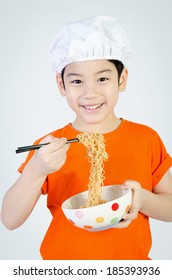 Asian Cute Child Eating Ramen Noodles In Ceramic Bowl .