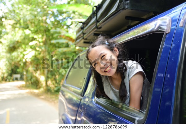 Asian cute girl feel good on the car go to travel Forest\
National Park 