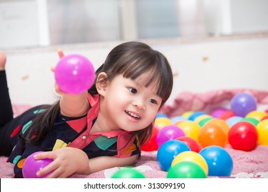 Asian Cute Girl Playing Ball Toy.