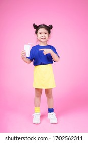 Asian Cute Little Girl Kid With Lovely Expression In Pinky Background Holding Milk Box