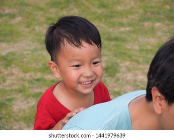 Asian Cute Young Kid Playing With Dad With Happy Face In Park, Son Hide Behind His Father With Smiling Face, Lovely Boy Playing Peekaboo With Dad,relax Time  