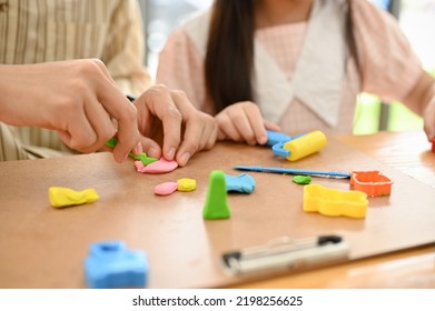 Asian Dad And Daughter Playing Play Dough, Sculpting, Moulding Colorful Clay Together. Cropped Image