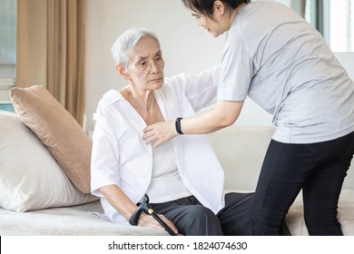 Asian daughter in charge is helping to dress up,chang clothes for a helpless old patient,taking care of senior mother suffer from stroke,lacking strength,decrepit of person,elderly woman and infirm - Shutterstock ID 1824074630