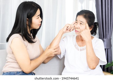 Asian Daughter Helping And Support Her Elderly Mother From Alzheimer Disease Problem, Mom Losing Memory  Trying To Recognize Daughter  