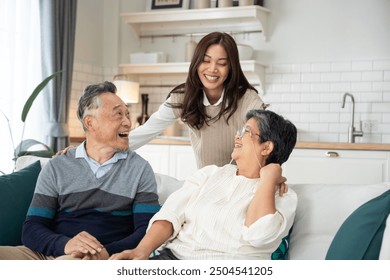 Asian daughter shared a moment of joy with her parent, engaging in a lively conversation that brought laughter and smiles. They embraced in a warm hug, cherishing the special bond between them - Powered by Shutterstock