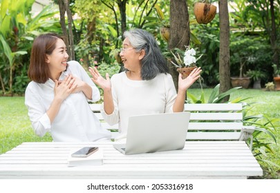 Asian Daughter Teaching Old Elderly Woman Use Online Social Media In Computer Laptop After Retirement. Concept Of Learning Technology And Adaptation Of The Elderly