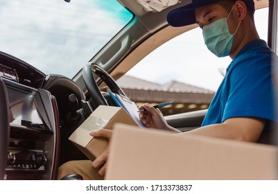 Asian Delivery Courier Young Man Driver Inside The Van Car With Parcel Post Boxes Checking Amount He Protective Face Mask, Under Curfew Quarantine Pandemic Coronavirus COVID-19