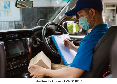 Asian Delivery Courier Young Man Driver Inside The Van Car With Parcel Post Boxes Checking Amount He Protective Face Mask, Under Curfew Quarantine Pandemic Coronavirus COVID-19