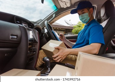 Asian Delivery Courier Young Man Driver Inside The Van Car With Parcel Post Boxes Checking Amount He Protective Face Mask, Under Curfew Quarantine Pandemic Coronavirus COVID-19