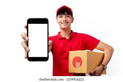 Asian delivery man carrying paper parcel Showing his payment application on the smart phone on white background. Shopping via online, Postal delivery service concept. - Powered by Shutterstock