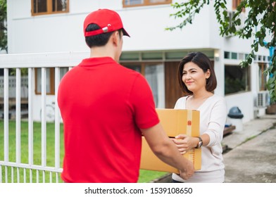 Asian Delivery Man Deliver Box Parcel Package To Customer At Home, Shipping Delivery Concept