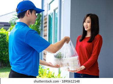 Asian Delivery Man Delivering Food, Fruit, Juice And Vegetable To Customer Home - Online Grocery Shopping Service Concept