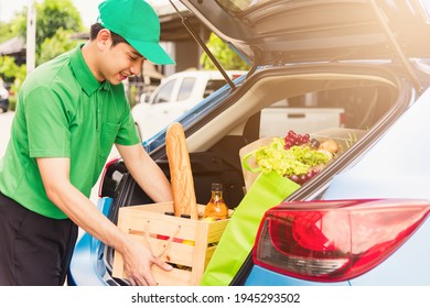 Asian Delivery Man Grocery Prepare Service Giving Fresh Vegetables Food And Fruit Full In Wooden Basket On Back Car To Send Woman Customer At Door Home After Pandemic Coronavirus, Back To New Normal