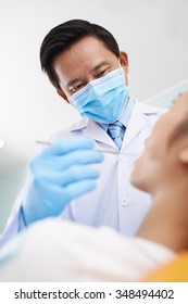 Asian Dentist Treating Female Patient