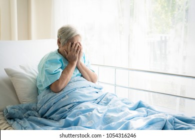 Asian Depressed Elderly Woman Patients Lying On Bed Looking Out The Window In Hospital. Elderly Woman Patients Is Glad Recovered From The Illness.