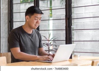 asian developer working in a coffee shop