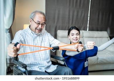 Asian Disabled senior elderly man on wheelchair doing physiotherapist with support from therapist nurse. Older handicapped man using resistance stretch band exercise for patient in home nursing care. - Powered by Shutterstock