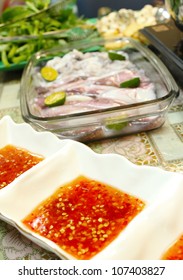 Asian Dishes - Spicy Dipping Sauce For Steamboat And Fresh Squids Set In Shallow Depth Of Field