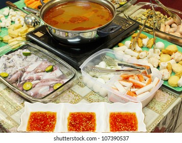 Asian Dishes - Tomyam Steamboat Set With Various Ingredients And Spicy Dipping Sauce