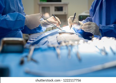Asian doctor and an assistant in the operating room for surgical venous vascular surgery clinic in hospital. - Shutterstock ID 1222117756