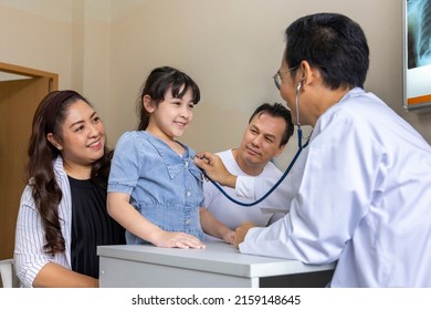 Asian Doctor Is Diagnosis Young Girl Using Stethoscope For Lung Checkup And Side Effect On Coronavirus With Parent And Family In Her Appointment In Hospital