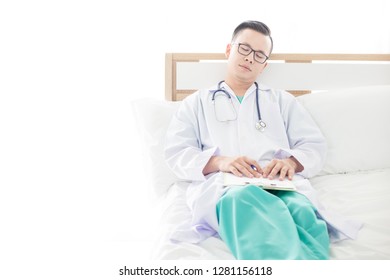 Asian Doctor Feeling Tired And Sleeping On White Bed In Private Room, Healthcare Worker