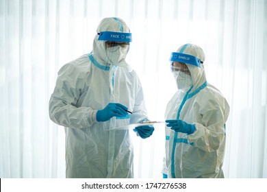 Asian Doctor Holding Checking Coronavirus Or Covid-19 Infected Patient Name List Sheet In Quarantine Area In Hospital. Corona Virus, Covid 19 Virus Outbreak, Medical Mask Or Virus Outbreak Concept