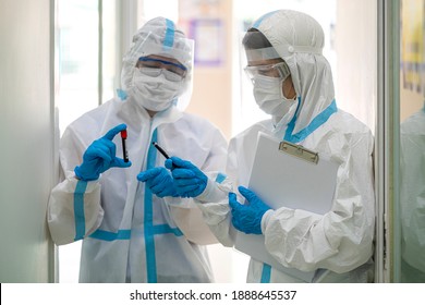 Asian Doctor Holding Checking Coronavirus Or Covid-19 Infected Patient Name List Sheet In Quarantine Area In Hospital. Corona Virus, Covid 19 Virus Outbreak, Medical Mask Or Virus Outbreak Concept