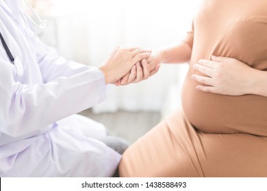 Asian Doctor Holding Hand Of Pregnancy People, They Talk About Pregnant Information, Antenatal Care Activity, Hand In Hand