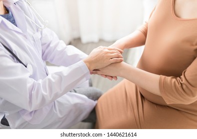 Asian Doctor Holding Hand Of Pregnancy People, They Talk About Pregnant Information, Antenatal Care Activity, Hand In Hand