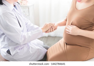 Asian Doctor Holding Hand Of Pregnancy People, They Talk About Pregnant Information, Antenatal Care Activity, Hand In Hand