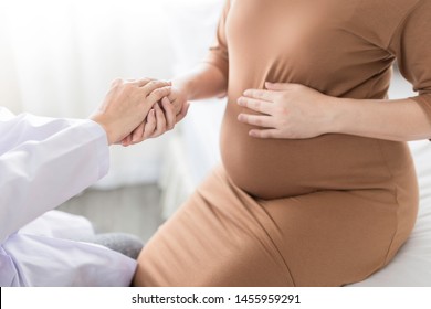 Asian Doctor Holding Hand Of Pregnancy People, They Talk About Pregnant Information, Antenatal Care Activity, Hand In Hand