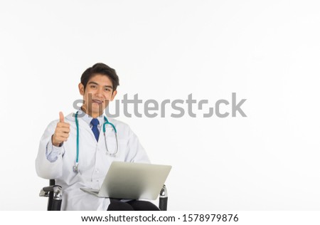 An Asian doctor holding a notebook and his thumb on a whitebackground.