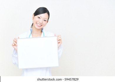 Asian Doctor Holding A White Board