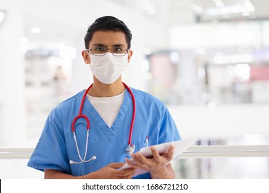 Asian doctor or nurse with stethoscope and face mask. Medical specialist during coronavirus outbreak in Asia. Virus pandemic. Hospital and clinic staff. Sickness prevention. Health care professional.