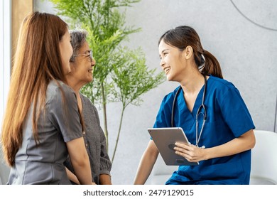 Asian Doctor or Nurse Talking to Senior Patient and Daughter in Hospital or clinic, showing Medical Results on Digital tablet, Medicine and health care - Powered by Shutterstock