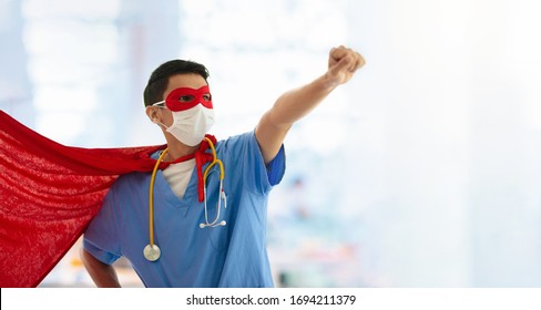 Asian Doctor Or Nurse Wearing Surgical Face Mask In Superhero Cape. Medical Staff During Coronavirus Outbreak In Asia. Super Hero Power For Clinic And Hospital Personal.