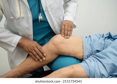 Asian doctor physiotherapist examining, massaging and treatment knee and leg of senior patient in orthopedist medical clinic nurse hospital. - Powered by Shutterstock