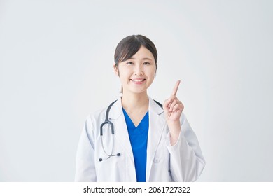 Asian Doctor Pointing Side In White