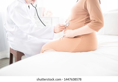 Asian Doctor Screening Pregnant Asian Female, Pregnancy Health Check Up, Doctor Use Stethoscope Listening Heart Rate Of Fetus