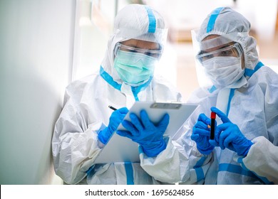 Asian doctor show corona or covid-19 blooding tube wearing ppe suit and face mask in hospital. Corona virus, Covid-19, virus outbreak, medical mask, hospital, quarantine or virus outbreak concept