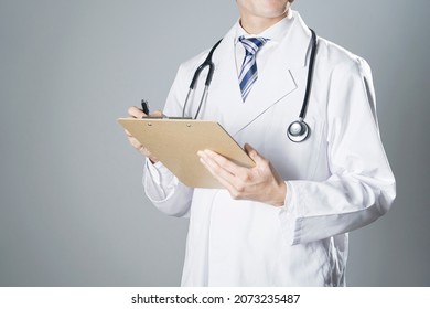 Asian Doctor Standing In Dark, No Face
