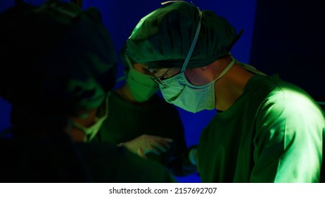 Asian Doctor With Surgical Team In Operating Room