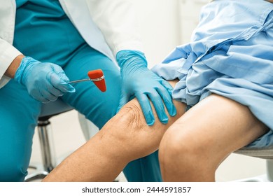 Asian doctor use hammer knock senior woman patient to check knee reflex, nerve and muscle in hospital. - Powered by Shutterstock