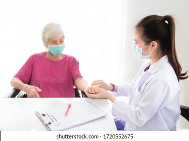 Asian Doctor Use Hand Screening Vital Sign Of Old Asian Patient, Doctor Treatment Patient In Hospital, Elderly Health Check Up, They Wear Surgical Mask