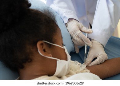 Asian Doctor User Syringe Needle For Injection Vaccinate,  African American Children Are Being Covid Vaccinated For Prevention Coronavirus And Flu. Concept Of Immunization From Inoculation