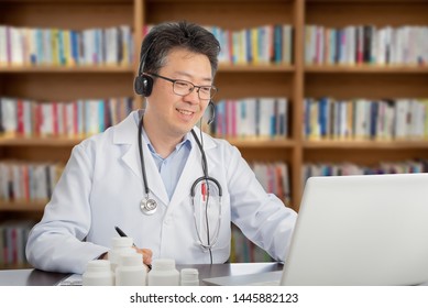 An Asian Doctor Who Is Remotely Consulting With A Patient. Telehealth Concept.