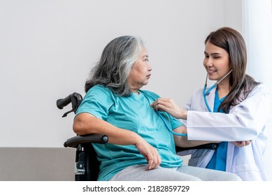 An Asian Doctor Woman Using A Stethoscope Listen To Heart Rate Of Elderly Woman Patients To Check For Heart Disease, To Annual Health Check Of The Elderly And Health Care  Concept.